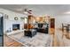 Spacious living room with hardwood floors, fireplace, and open layout connecting to the kitchen and dining area at 241 Burke Cir, Mcdonough, GA 30253