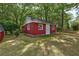This charming outbuilding boasts windows and a door, nestled in a yard with mature trees at 241 Burke Cir, Mcdonough, GA 30253