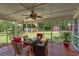 Cozy screened-in porch with comfortable seating and views of the backyard and outbuildings at 241 Burke Cir, Mcdonough, GA 30253