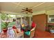 Inviting screened-in porch with comfortable seating and an outdoor fan, perfect for relaxation at 241 Burke Cir, Mcdonough, GA 30253