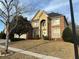 Two-story brick home with manicured lawn, arched entry, and attached two car garage at 3270 Moon Beam Ct, Snellville, GA 30039