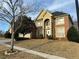 Two-story brick home with manicured lawn, arched entry, and attached two car garage at 3270 Moon Beam Ct, Snellville, GA 30039