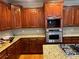 Gourmet kitchen featuring stainless steel appliances, granite countertops, and custom wood cabinets at 3270 Moon Beam Ct, Snellville, GA 30039