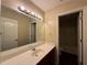 Well-lit bathroom featuring a large mirror, vanity, and a view of the shower at 4500 Nocohoma Bnd, Douglasville, GA 30135