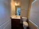 Well-lit half bathroom with modern fixtures, a vanity sink, and hardwood floors at 4500 Nocohoma Bnd, Douglasville, GA 30135
