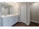 Bathroom with double vanity, modern lighting, and tiled shower at 4500 Nocohoma Bnd, Douglasville, GA 30135