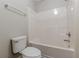 Bright bathroom featuring a toilet and shower-tub combination at 4500 Nocohoma Bnd, Douglasville, GA 30135