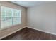 Bright bedroom features wood-look flooring and a window with natural light at 4500 Nocohoma Bnd, Douglasville, GA 30135