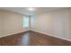 Well lit bedroom with hardwood floors and a window at 4500 Nocohoma Bnd, Douglasville, GA 30135