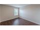 Bright bedroom featuring wood-look floors and a large window at 4500 Nocohoma Bnd, Douglasville, GA 30135