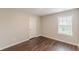 Bright bedroom featuring hardwood floors, neutral paint, and a large window at 4500 Nocohoma Bnd, Douglasville, GA 30135