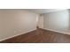 Neutral bedroom with hardwood floors and a view into the hallway at 4500 Nocohoma Bnd, Douglasville, GA 30135