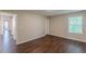 This bedroom features wood-look floors, a window with blinds and neutral walls at 4500 Nocohoma Bnd, Douglasville, GA 30135