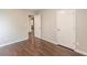 Bedroom features wood-look flooring, neutral walls, and white doors at 4500 Nocohoma Bnd, Douglasville, GA 30135