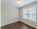 Well-lit bedroom offers wood-look floors and a large window at 4500 Nocohoma Bnd, Douglasville, GA 30135