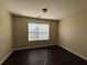 Comfortable bedroom with hardwood floors and a large window providing natural light at 4500 Nocohoma Bnd, Douglasville, GA 30135