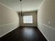 Formal dining room with a decorative chandelier and hardwood floors at 4500 Nocohoma Bnd, Douglasville, GA 30135