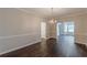 Light-filled dining room featuring hardwood floors, trim work, and a view into other living areas at 4500 Nocohoma Bnd, Douglasville, GA 30135