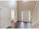 Bright entryway featuring hardwood floors, white staircase and a bathroom nearby at 4500 Nocohoma Bnd, Douglasville, GA 30135