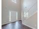Bright entryway boasting hardwood floors, a white staircase, and natural light at 4500 Nocohoma Bnd, Douglasville, GA 30135