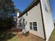 Exterior view of a two-story home with light siding and an AC unit at 4500 Nocohoma Bnd, Douglasville, GA 30135