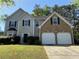 Charming two-story home with a brick facade, well-maintained lawn, and a two-car garage at 4500 Nocohoma Bnd, Douglasville, GA 30135