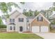 Inviting two-story home with a brick-accented two-car garage, complemented by a well-manicured lawn at 4500 Nocohoma Bnd, Douglasville, GA 30135