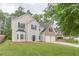 Charming two-story home featuring a two-car garage and a spacious front yard at 4500 Nocohoma Bnd, Douglasville, GA 30135