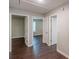 Hallway with wood floors and open doorways leading to various rooms at 4500 Nocohoma Bnd, Douglasville, GA 30135