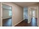 Hallway with hardwood floors leading to other rooms with natural light at 4500 Nocohoma Bnd, Douglasville, GA 30135