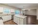 Well-lit kitchen features white cabinets, granite countertops, stainless appliances, and a center island at 4500 Nocohoma Bnd, Douglasville, GA 30135
