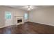 Spacious living room with fireplace, ceiling fan and hardwood floors bathed in natural light at 4500 Nocohoma Bnd, Douglasville, GA 30135