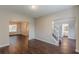 Open concept living room featuring beautiful dark wood floors, neutral paint colors, and natural light at 4500 Nocohoma Bnd, Douglasville, GA 30135
