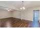 Open-concept living room with ceiling fan and hardwood floors bathed in natural light at 4500 Nocohoma Bnd, Douglasville, GA 30135