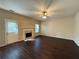 Inviting living room with a cozy fireplace, ceiling fan and hardwood floors at 4500 Nocohoma Bnd, Douglasville, GA 30135