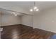 Open-concept living room with ceiling fan and hardwood floors bathed in natural light at 4500 Nocohoma Bnd, Douglasville, GA 30135