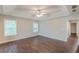 Main bedroom featuring wood-look floors, tray ceiling, and window views at 4500 Nocohoma Bnd, Douglasville, GA 30135