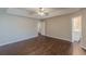 Main bedroom with wood-look flooring, tray ceiling, and bathroom entrance at 4500 Nocohoma Bnd, Douglasville, GA 30135