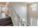 View of a staircase with white railing and wood steps, bathed in natural light at 4500 Nocohoma Bnd, Douglasville, GA 30135