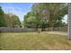 Large backyard with green grass, patio, fire pit, and fenced perimeter at 1265 Birchwood Ln, Roswell, GA 30076