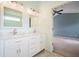 Bathroom with double sink vanity and a view into the primary bedroom at 1265 Birchwood Ln, Roswell, GA 30076