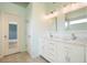 Bright bathroom with double sink vanity, tile floor, and great lighting at 1265 Birchwood Ln, Roswell, GA 30076