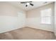 Bright bedroom with wainscoting, ceiling fan, double door closet, and a window at 1265 Birchwood Ln, Roswell, GA 30076