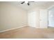 Cozy bedroom with ceiling fan, double door closet, and neutral carpeting at 1265 Birchwood Ln, Roswell, GA 30076