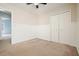 Bedroom featuring a ceiling fan, neutral carpeting, and double door closet at 1265 Birchwood Ln, Roswell, GA 30076