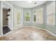 Sunlit breakfast nook with large windows and a door leading to the backyard at 1265 Birchwood Ln, Roswell, GA 30076