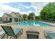 Large in-ground community pool with lounge chairs and clubhouse in background at 1265 Birchwood Ln, Roswell, GA 30076