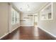 Dining room with hardwood floors, large window, and view of kitchen area at 1265 Birchwood Ln, Roswell, GA 30076