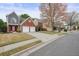 View of a two-story house with a two-car garage showcasing the front yard and surrounding neighborhood at 1265 Birchwood Ln, Roswell, GA 30076