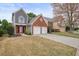 Street view of a two-story home with a two-car garage showing the front yard and neighborhood setting at 1265 Birchwood Ln, Roswell, GA 30076